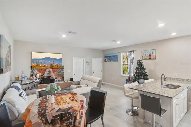 a living room with fireplace furniture and a potted plant