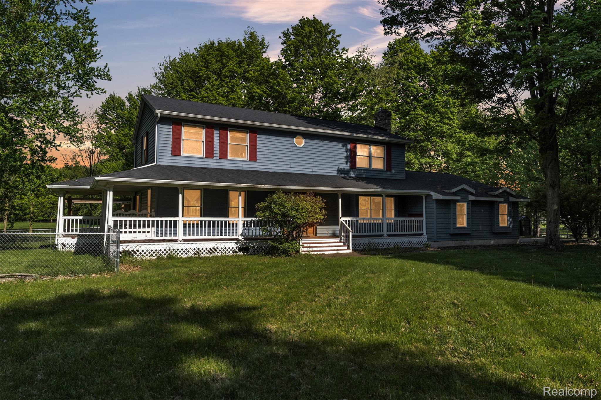 1345 Ives Road Mason, MI 48854 - Photo 1 of 92 Farmhouse inspired home with covered porch, a front lawn, a chimney, and view of wooded area
