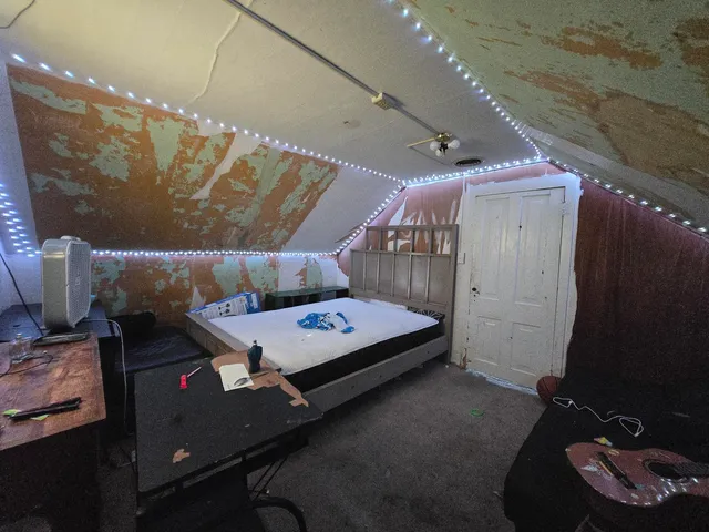 a bedroom with a bed and a mirror