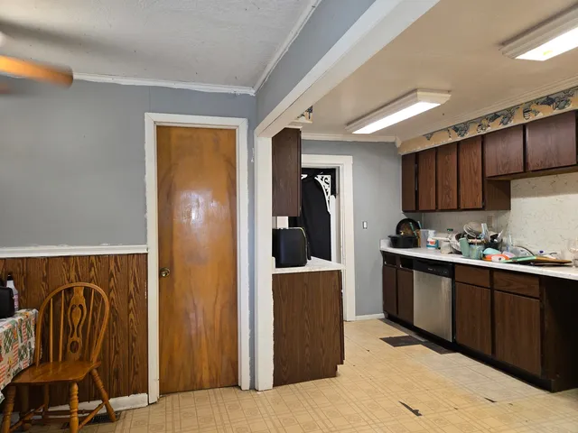 a kitchen with stainless steel appliances granite countertop a refrigerator and a stove top oven