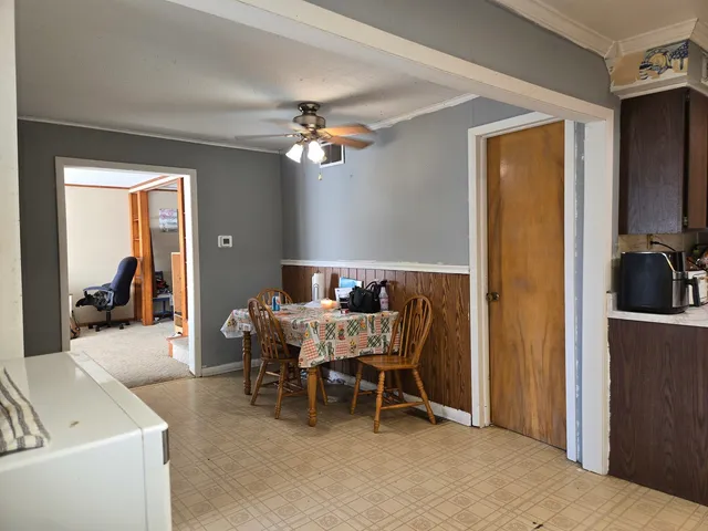 a view of a dining room with furniture and a chandelier