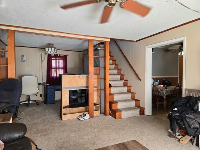 a view of hall way with furniture and staircase