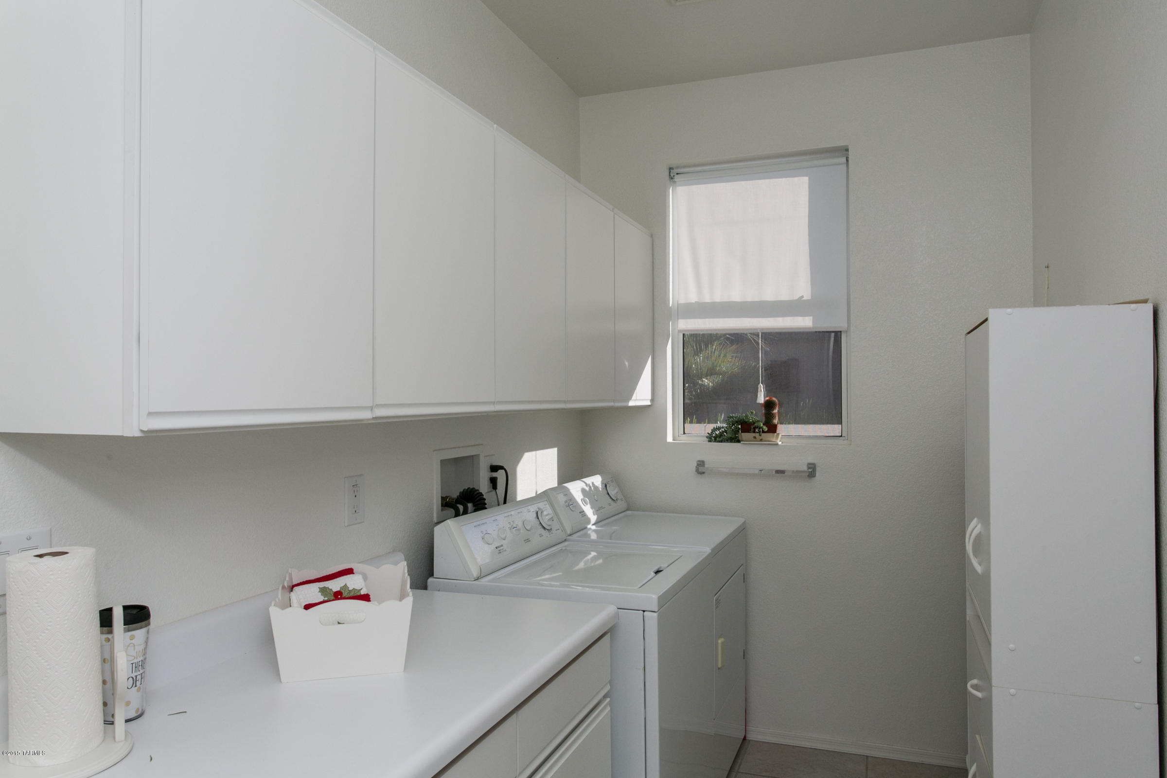 62419 East Northwood Road Tucson, AZ 85739 - Photo 19 of 30 a room with a sink and a refrigerator