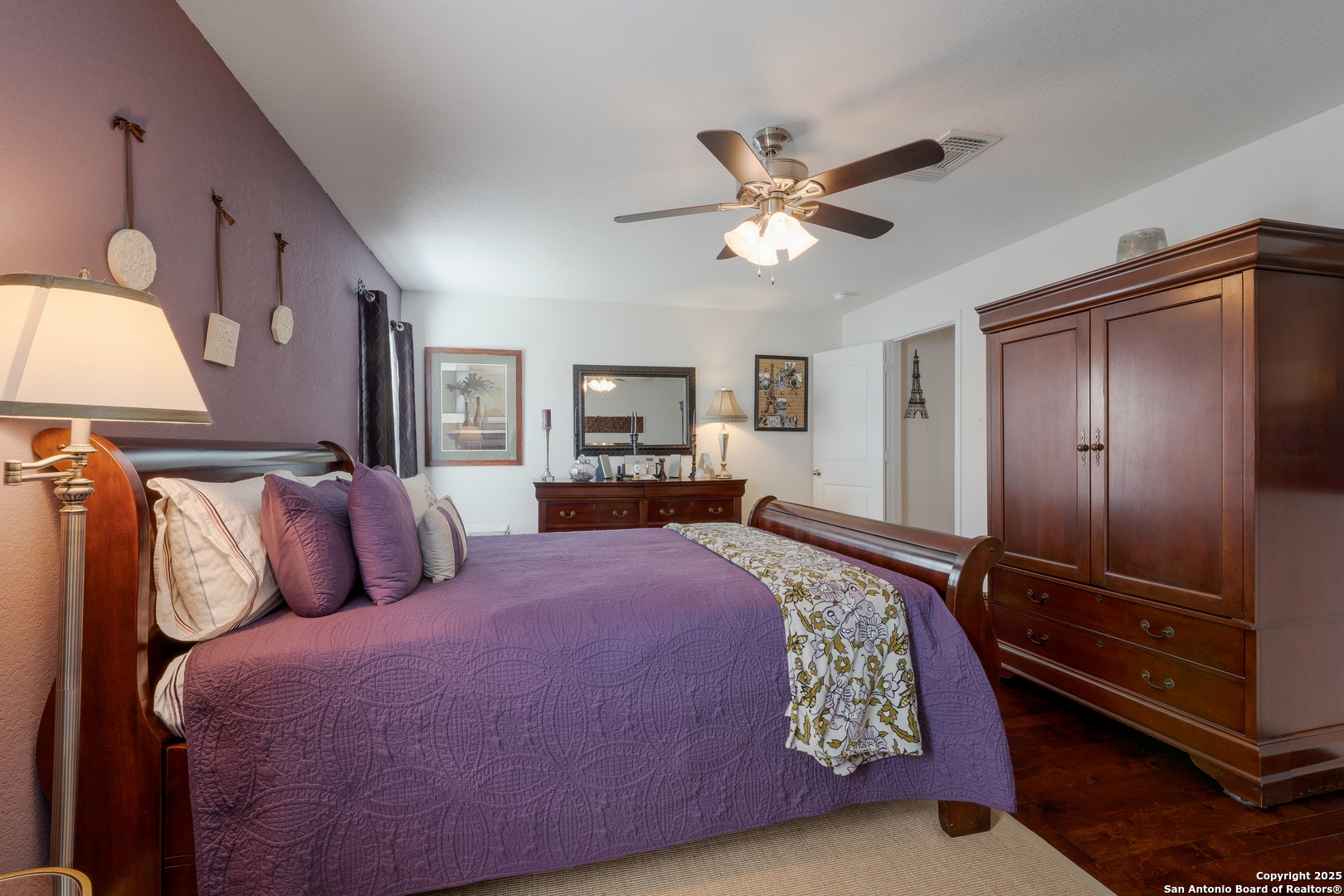 6226 Fred Couples Schertz, TX 78108 - Photo 18 of 30 a bedroom with a large bed and a chandelier