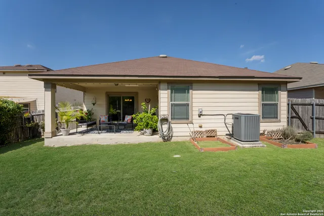 a view of a house with backyard porch and sitting area
