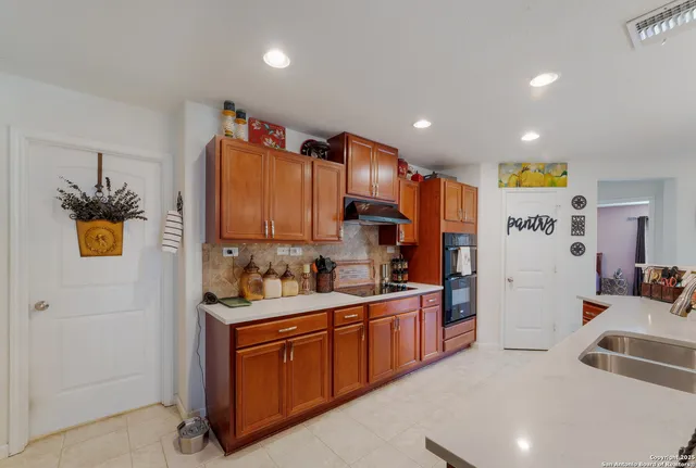 a bathroom with a sink double vanity granite tub shower and a mirror