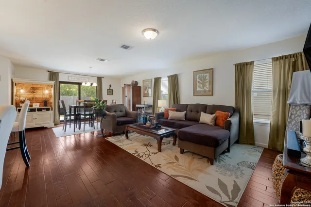 a living room with fireplace furniture and a wooden floor