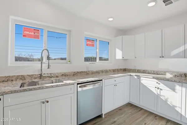 a kitchen with a sink cabinets and window