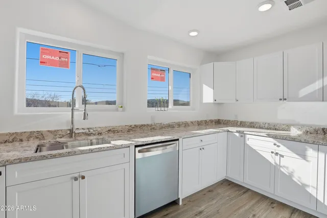 a kitchen with a sink cabinets and window