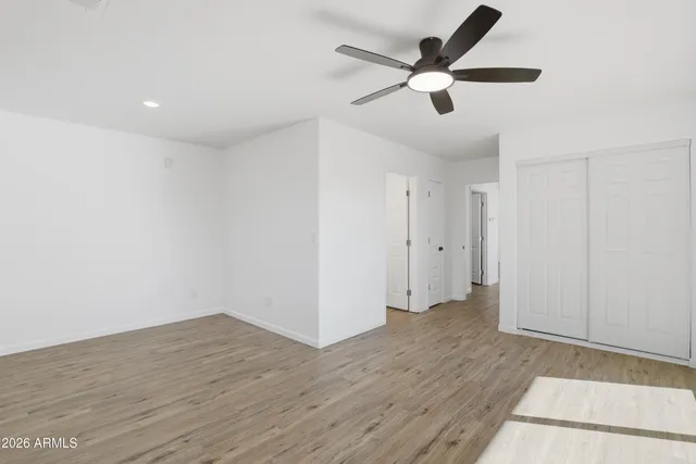 a view of an empty room with wooden floor