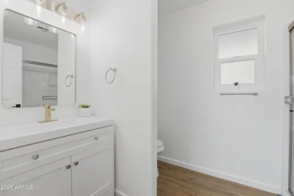a view of bathroom with a sink mirror and toilet