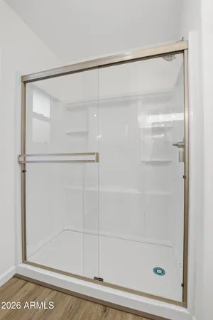 a bathroom with a glass shower door