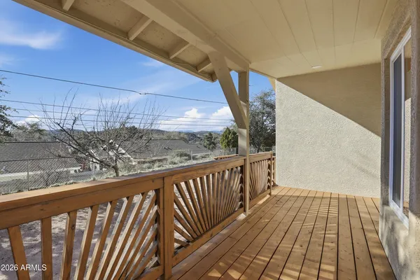 a view of a balcony with wooden floor