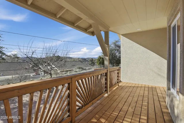 a view of a balcony with wooden floor