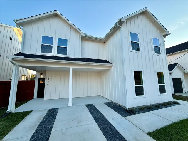 a view of house with backyard
