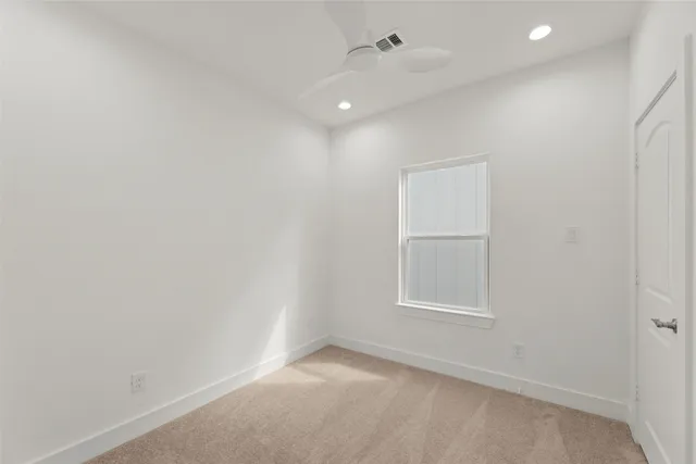 an empty room with windows and closet