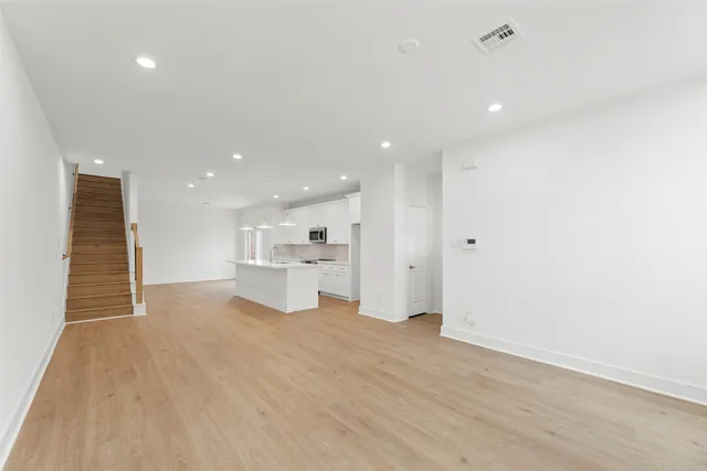 a view of a kitchen with a sink and a large window