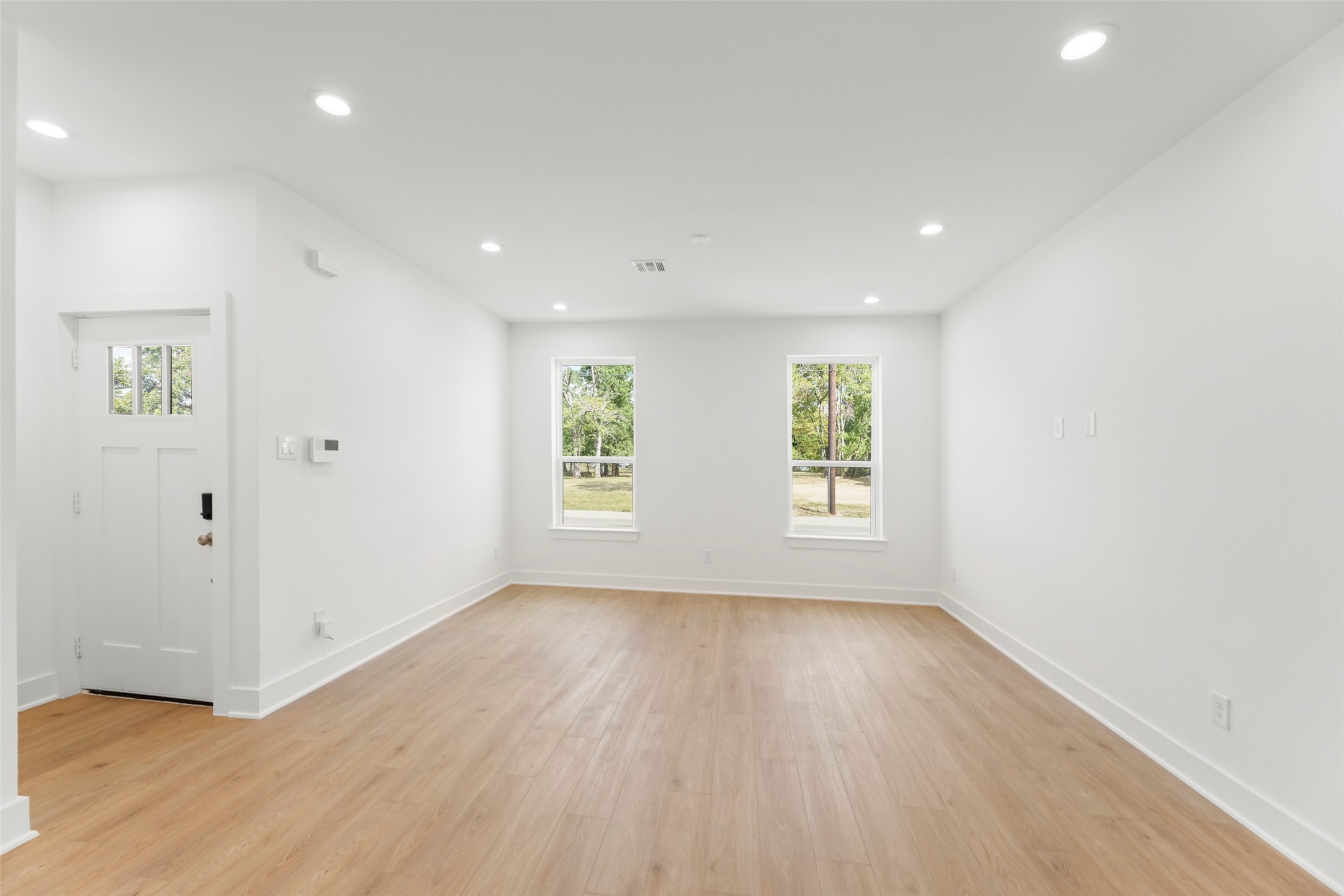 1477 Ferguson Way Houston, TX 77088 - Photo 21 of 37 an empty room with wooden floor and windows