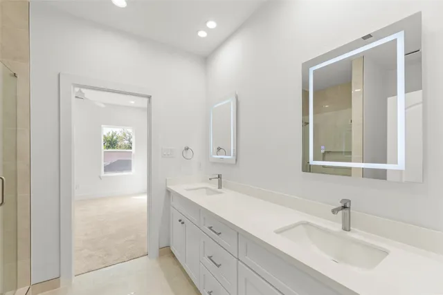 a bathroom with 2 sink tub and a mirror