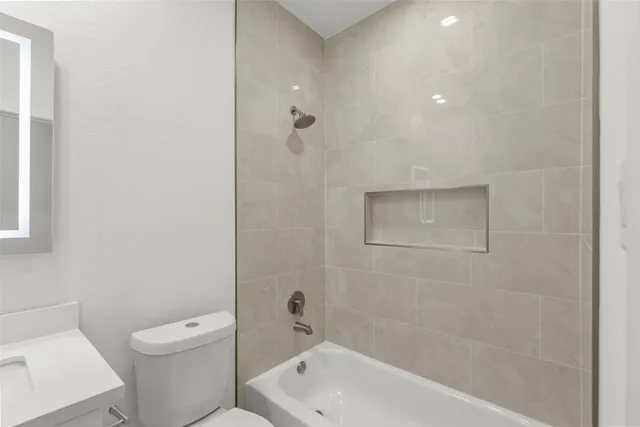 a bathroom with a toilet a sink and bathtub