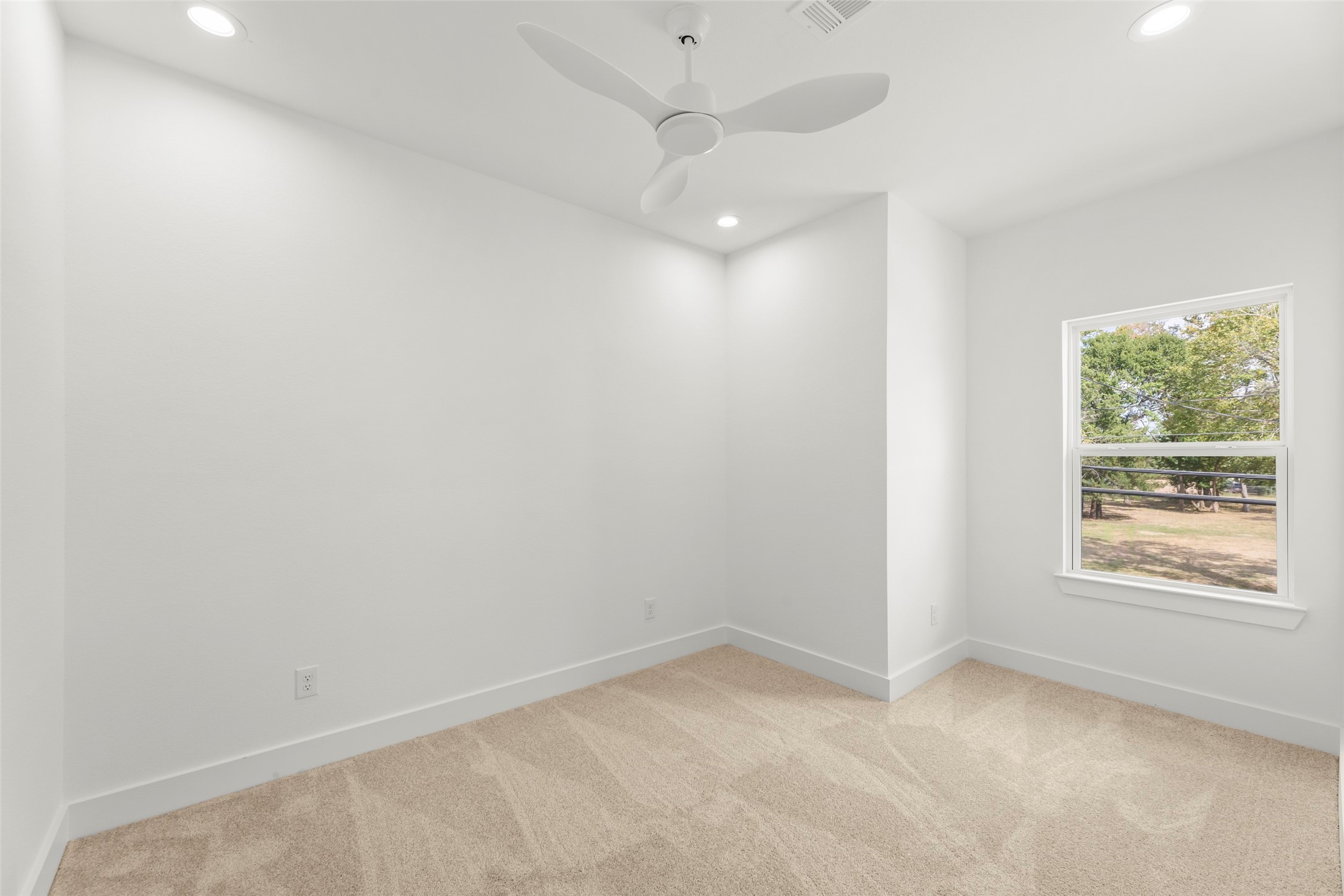 1477 Ferguson Way Houston, TX 77088 - Photo 32 of 37 an empty room with a window and a fan