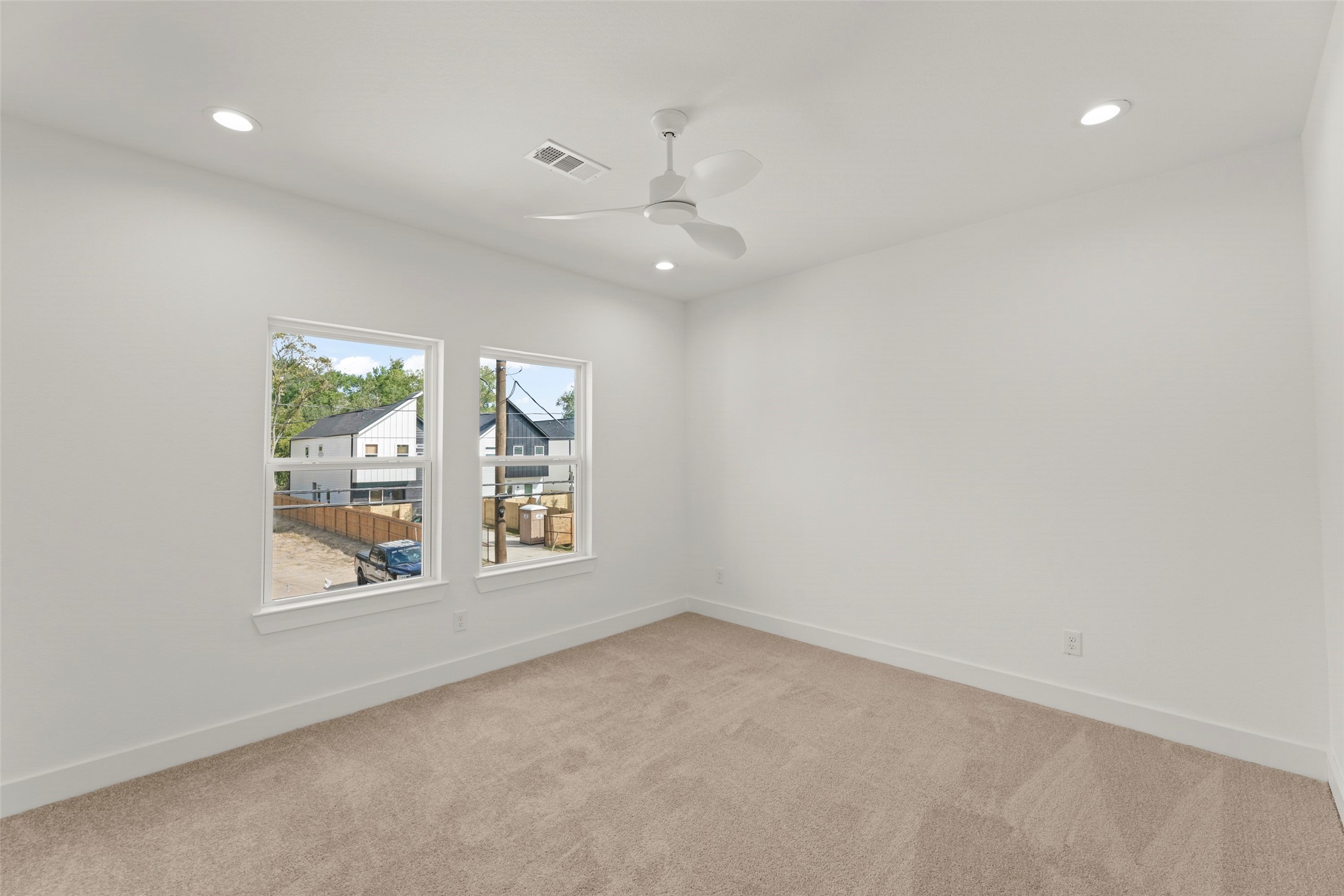 1477 Ferguson Way Houston, TX 77088 - Photo 7 of 37 an empty room with windows and ceiling fan