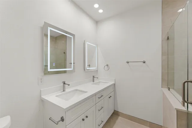 a bathroom with a double vanity sink a and mirror