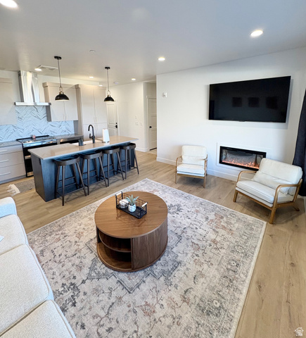 70 East Hwy 153, Unit A4 Beaver, UT 84713 - Photo 5 of 19 Living area with light wood-style floors, a glass covered fireplace, and recessed lighting