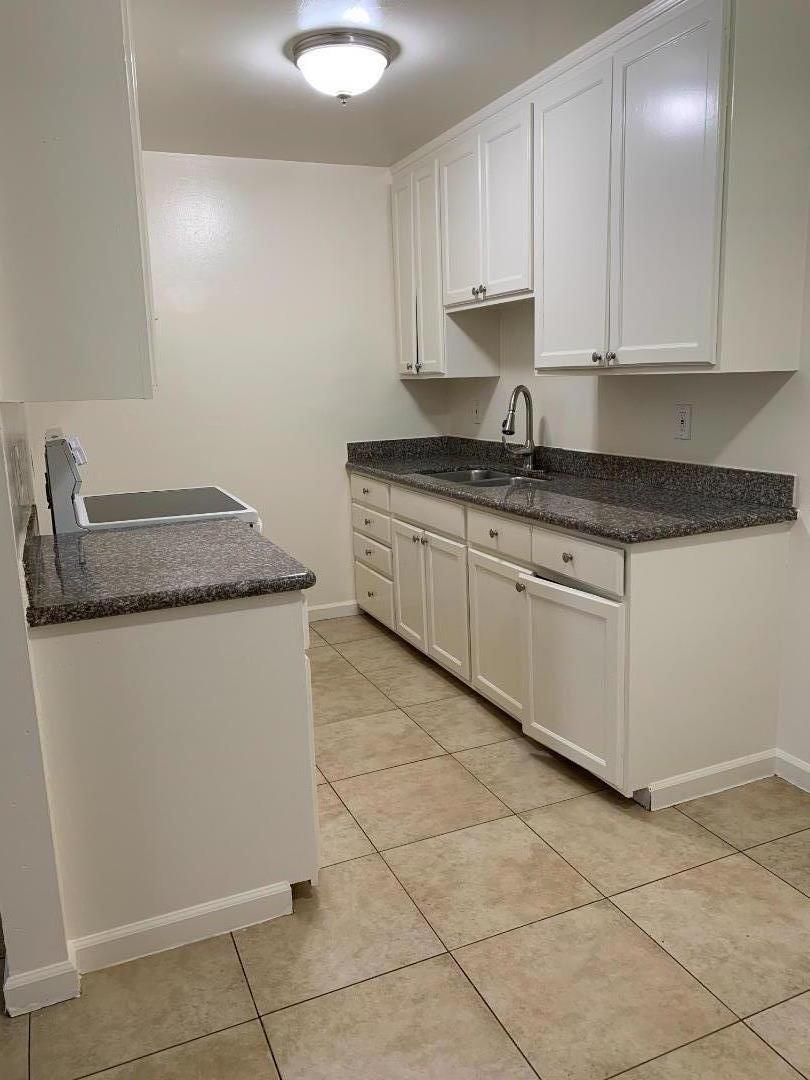 3786 Rolison Road Redwood City, CA 94063 - Photo 13 of 18 a kitchen with granite countertop a sink stove and cabinets