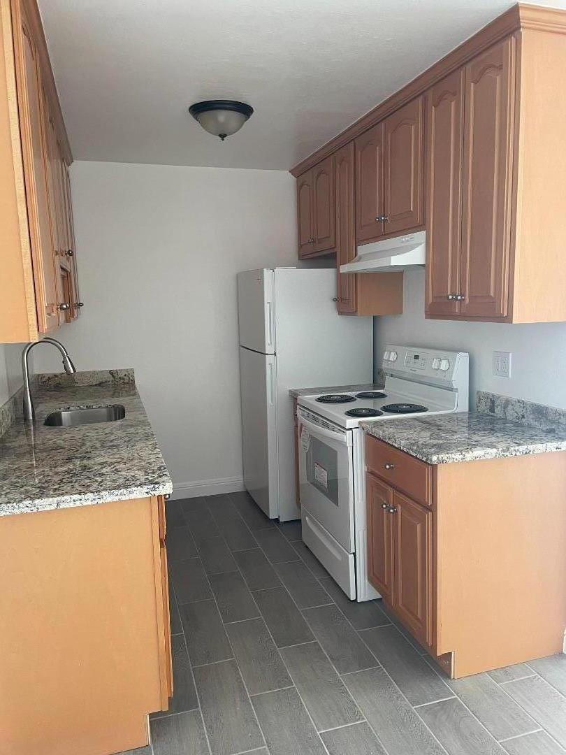 3786 Rolison Road Redwood City, CA 94063 - Photo 10 of 18 a kitchen with granite countertop a sink stove and refrigerator