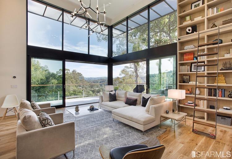 a living room with furniture a rug and a large window