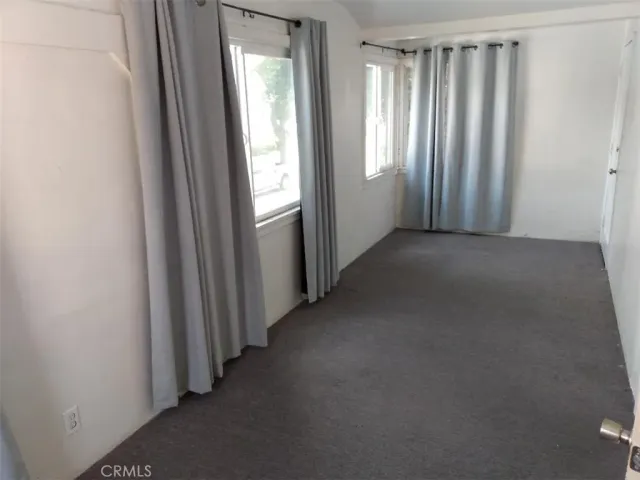 a view of a big room with windows and closet