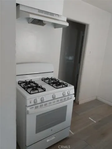 a stove top oven sitting inside of a kitchen