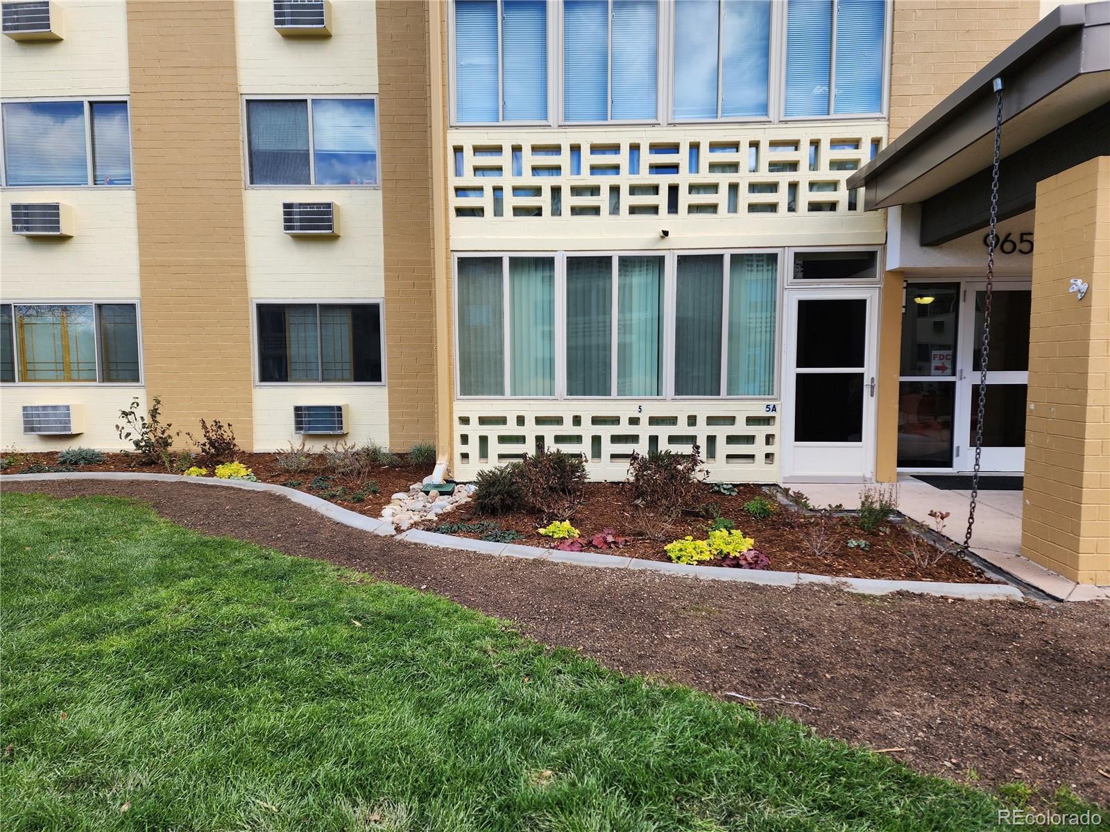 9655 Center Avenue, Unit 5A Denver, CO 80247 - Photo 1 of 45 a view of a house with a yard and sitting area