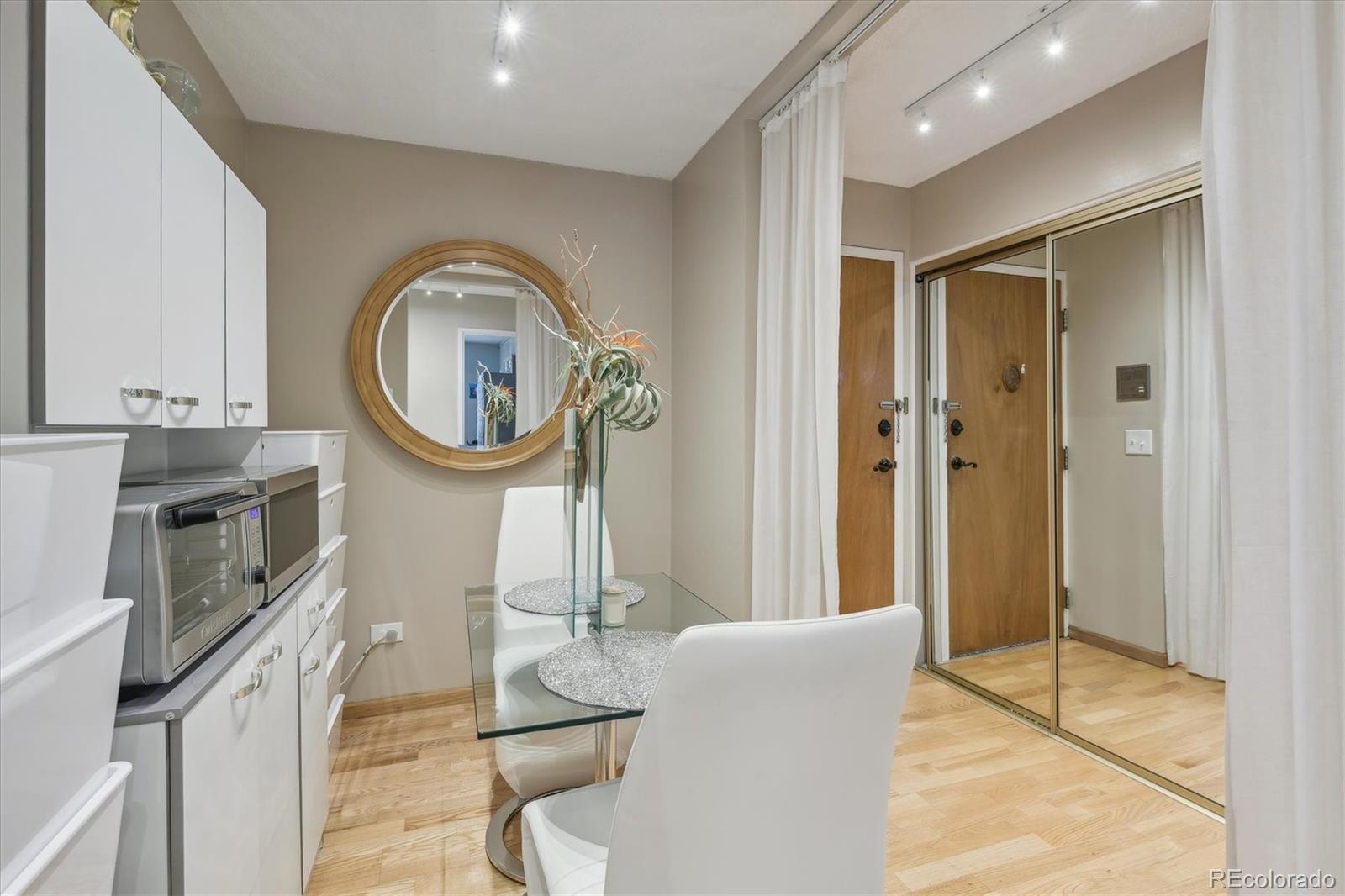 9655 Center Avenue, Unit 5A Denver, CO 80247 - Photo 11 of 45 a living room with furniture a mirror and a fireplace