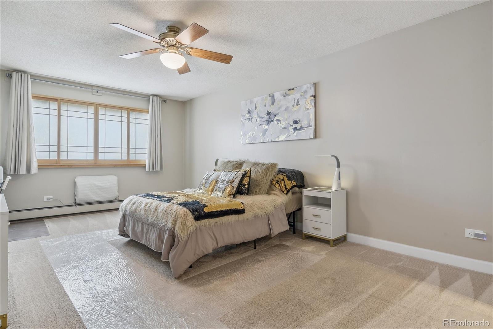 9655 Center Avenue, Unit 5A Denver, CO 80247 - Photo 12 of 45 a living room with furniture and a chandelier