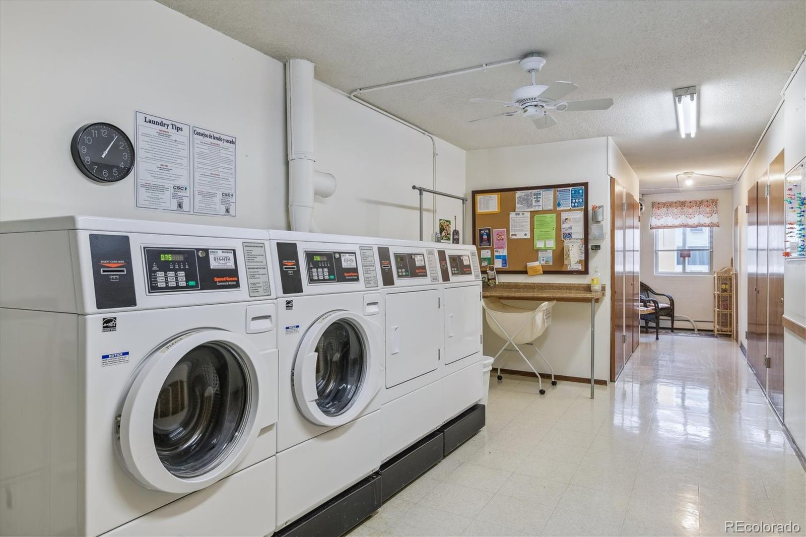 9655 Center Avenue, Unit 5A Denver, CO 80247 - Photo 17 of 45 a view of washer and dryer with kitchen in the background