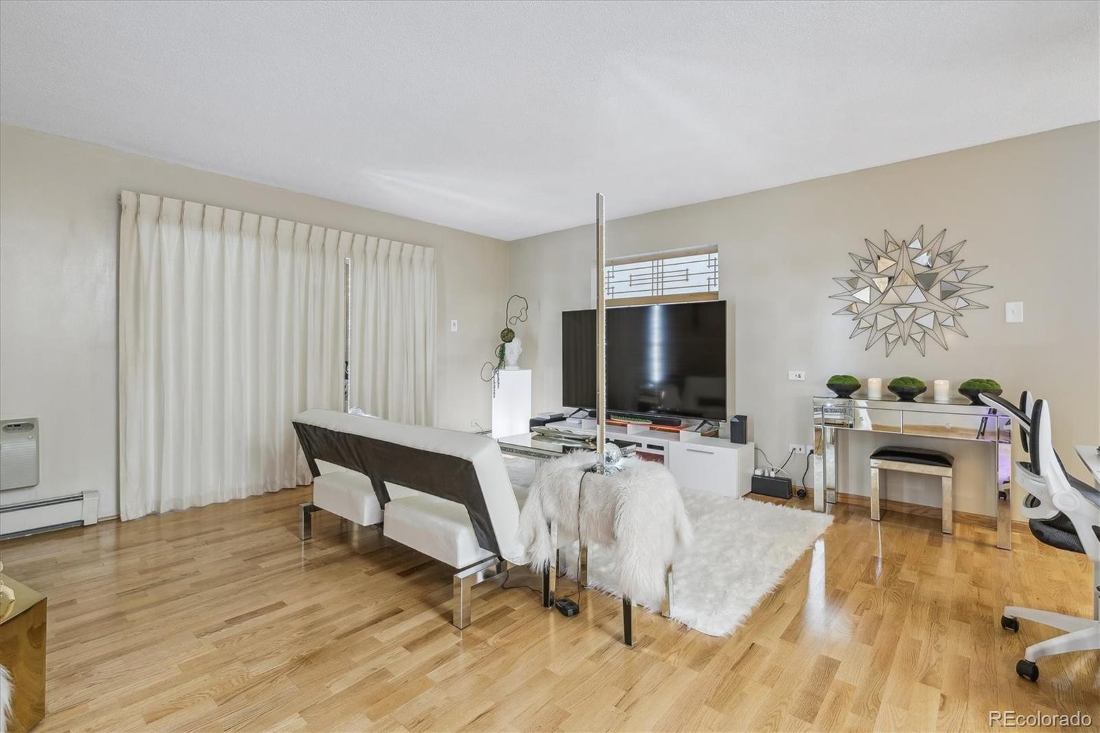 9655 Center Avenue, Unit 5A Denver, CO 80247 - Photo 6 of 45 a view of a livingroom with furniture and a flat screen tv