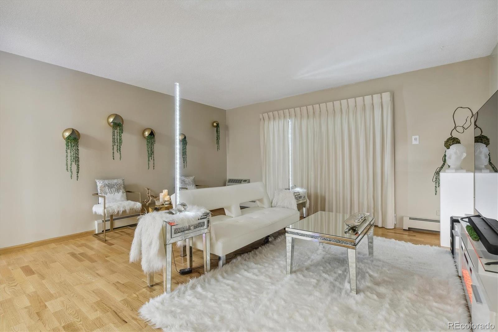 9655 Center Avenue, Unit 5A Denver, CO 80247 - Photo 7 of 45 a living room with furniture and a area