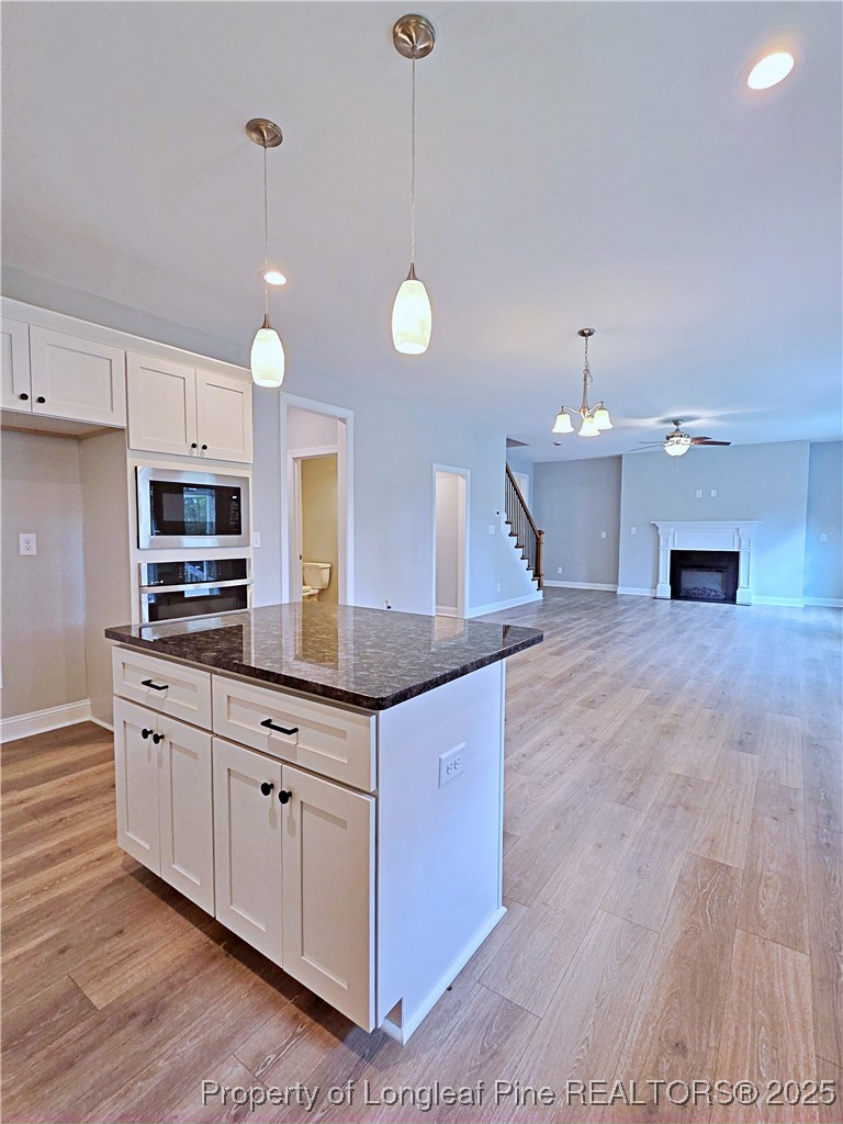 425 Shawcroft Road Fayetteville, NC 28311 - Photo 13 of 50 a kitchen with stainless steel appliances granite countertop a sink a stove and a wooden floors