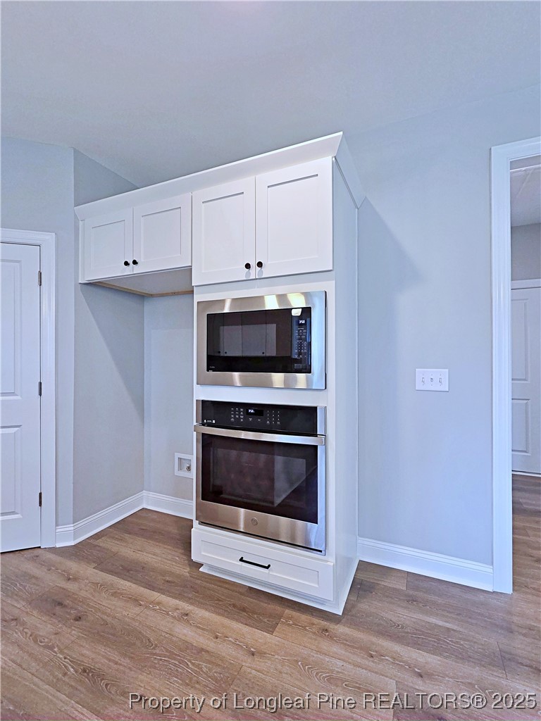 425 Shawcroft Road Fayetteville, NC 28311 - Photo 17 of 50 a kitchen with granite countertop a stove and a microwave with granite countertops