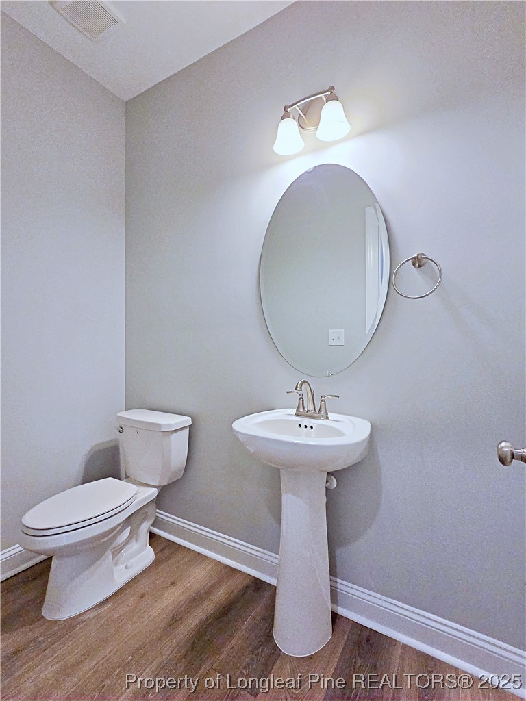 425 Shawcroft Road Fayetteville, NC 28311 - Photo 18 of 50 a bathroom with a toilet sink and mirror