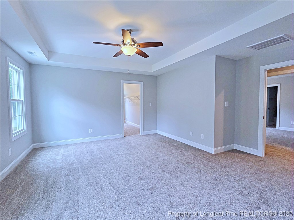 425 Shawcroft Road Fayetteville, NC 28311 - Photo 23 of 50 a view of an empty room with chandelier fan and window