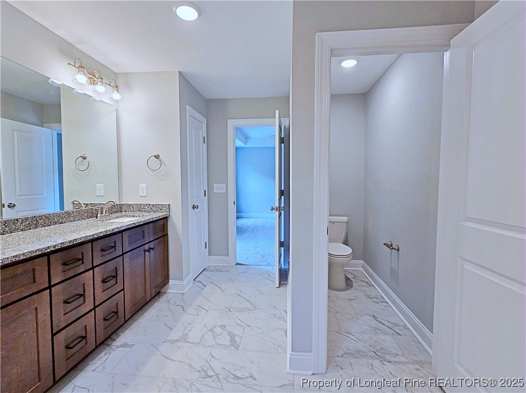 425 Shawcroft Road Fayetteville, NC 28311 - Photo 28 of 50 a bathroom with a granite countertop sink toilet and shower