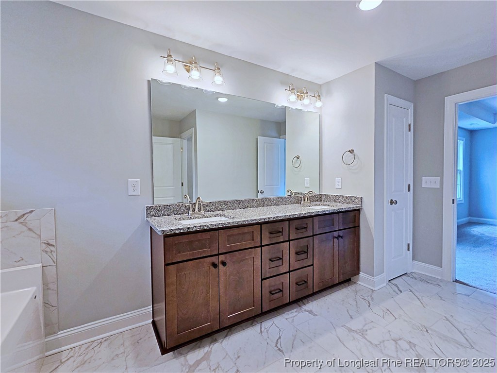 425 Shawcroft Road Fayetteville, NC 28311 - Photo 29 of 50 a bathroom with a granite countertop double vanity sink and a mirror