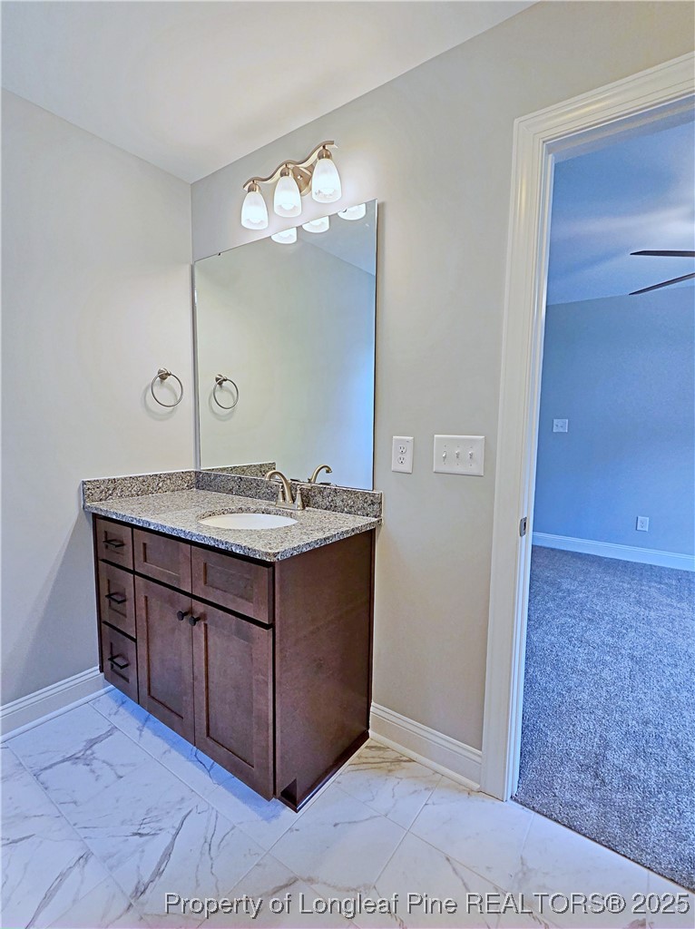 425 Shawcroft Road Fayetteville, NC 28311 - Photo 35 of 50 a bathroom with a granite countertop sink and a mirror