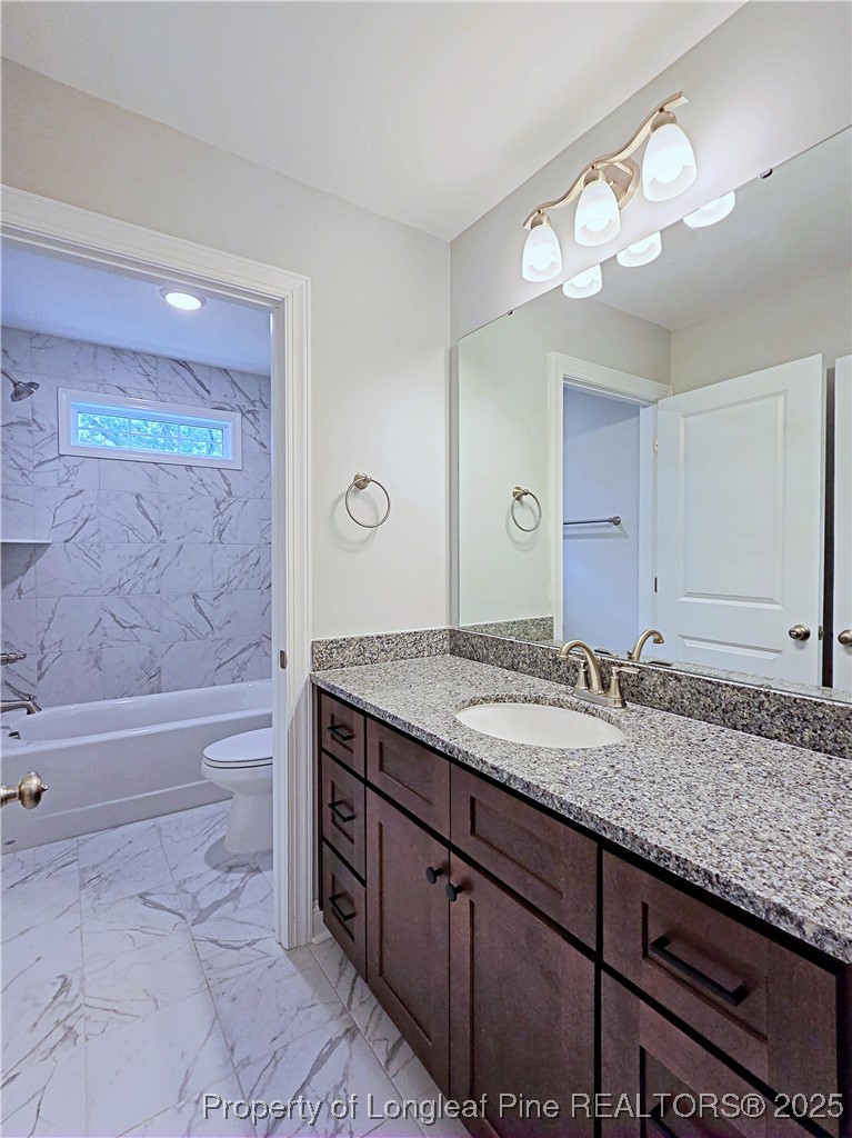 425 Shawcroft Road Fayetteville, NC 28311 - Photo 40 of 50 a bathroom with a granite countertop bathtub sink vanity and mirror