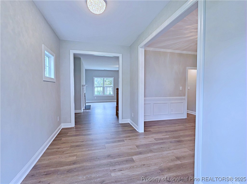 425 Shawcroft Road Fayetteville, NC 28311 - Photo 4 of 50 a view of an empty room with wooden floor and a mirror
