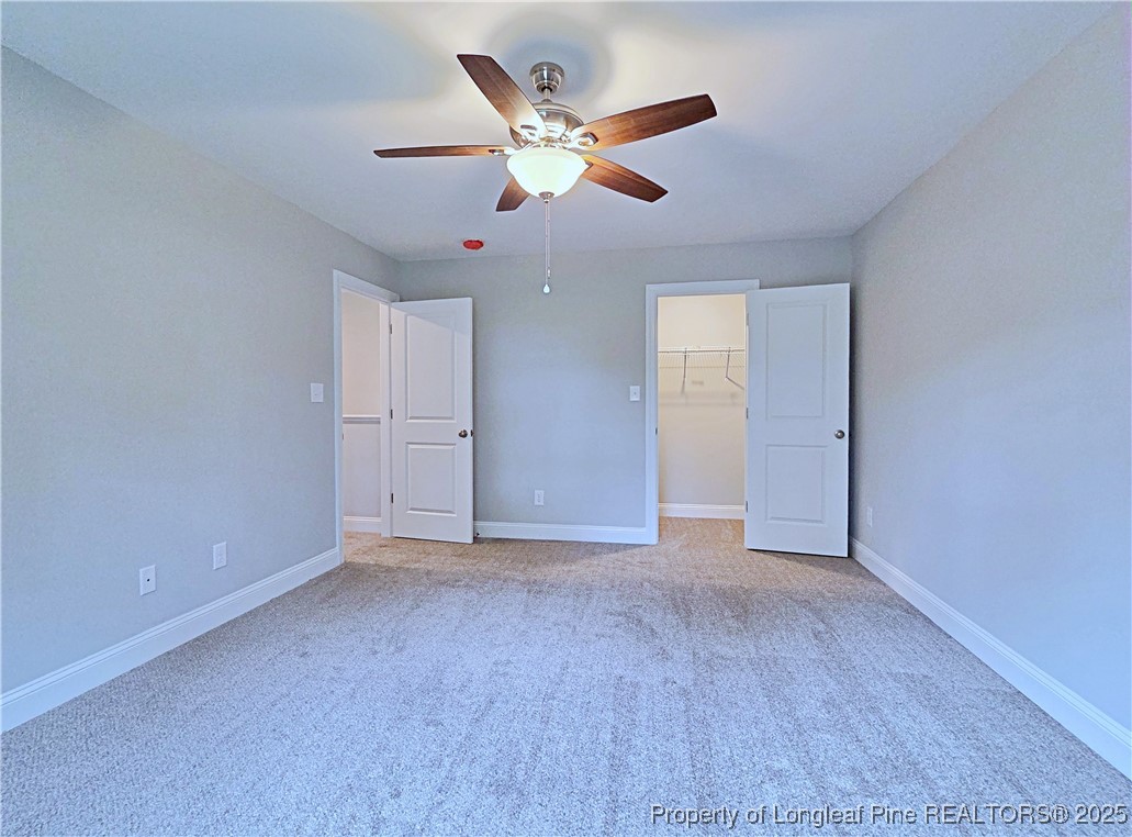 425 Shawcroft Road Fayetteville, NC 28311 - Photo 44 of 50 an empty room with closet and ceiling fan