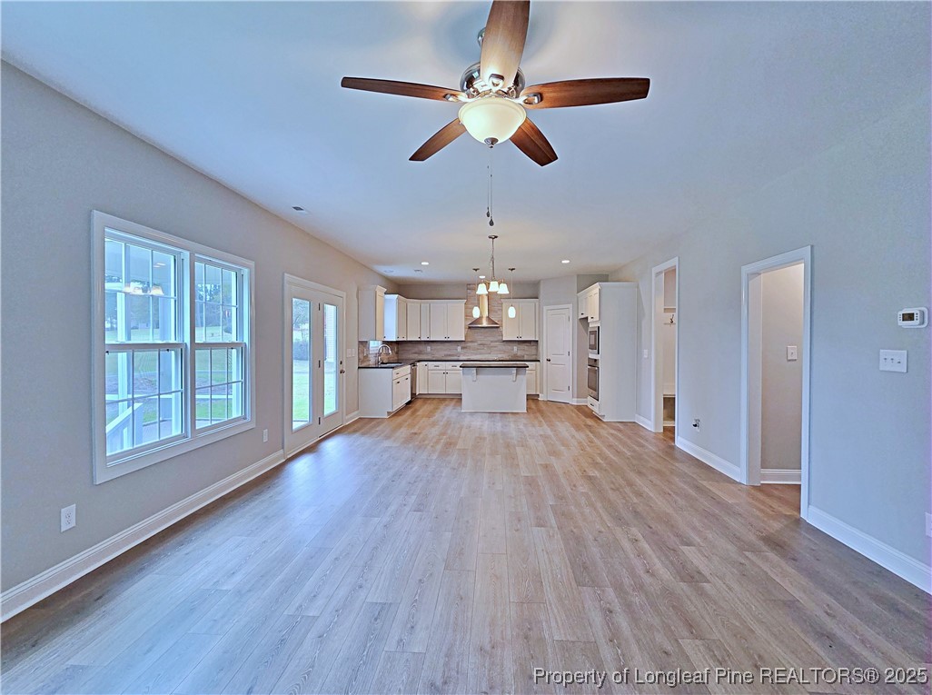 425 Shawcroft Road Fayetteville, NC 28311 - Photo 10 of 50 a view of empty room with wooden floor and fan